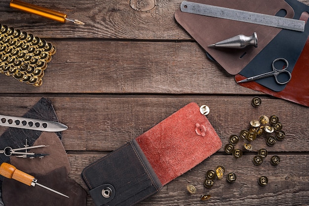 Leather craft or leather working leather working tools and cut out pieces of leather on work desk