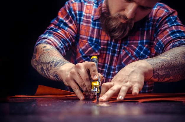 Leather Craftsman being keen on his buisness in the studio