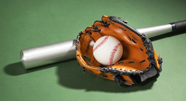 Leather glove with baseball and bat