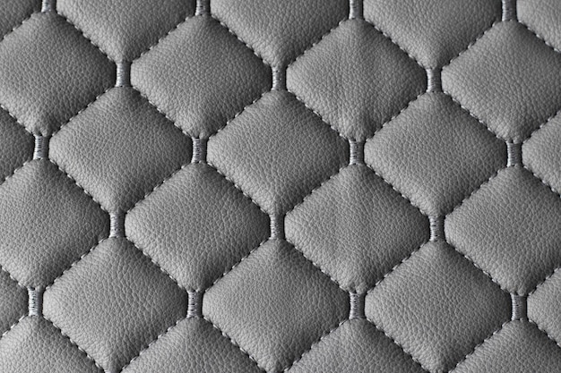 Leather gray fabric quilted stitched with synthetics Fabric for furniture upholstery Closeup