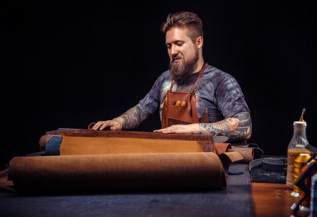 Leather Skinner produce a leatherwork at the tanner shop.