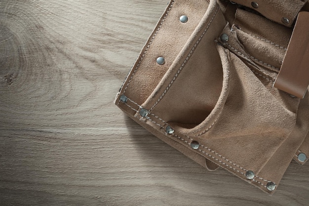 Leather tool belt on wooden board