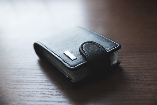 사진 신용 카드 용 가죽 지갑이 테이블 위에 놓여 있습니다.