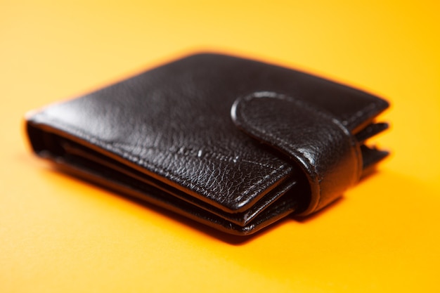 Leather wallet on orange surface