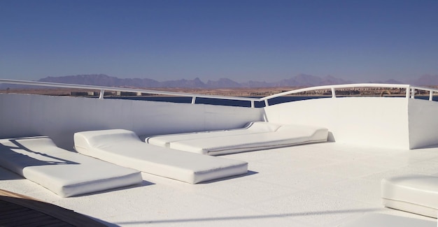 Leather white chaise lounges for rest on a yacht