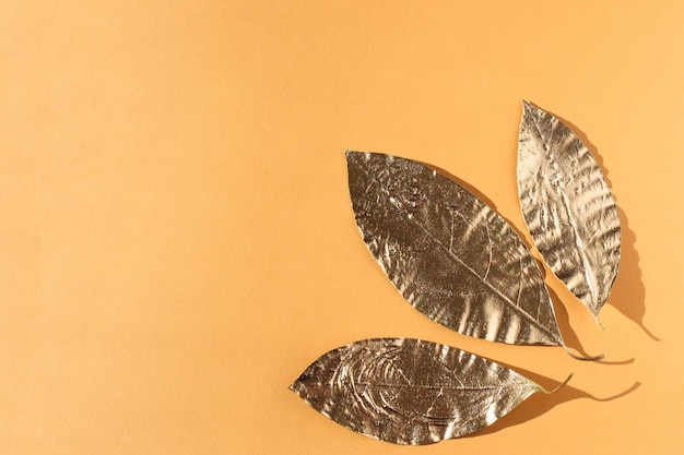 Leaves painted in gold on orange