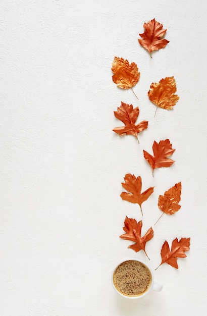 Leaves stained with gold paint on white