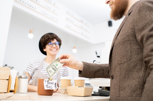 Leaving tip for friendly barista