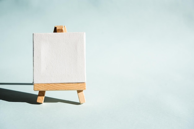 Lectern easel with white canvas and space for message on a light blue background