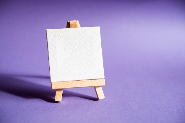 Lectern easel with white canvas and space for message on a purple background