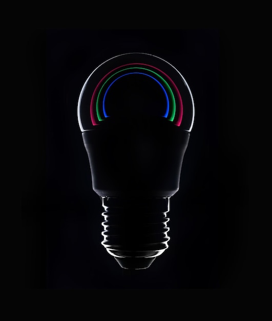 Photo led colored light bulb on a dark background closeup