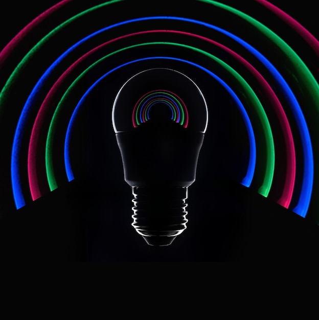 Led colored light bulb on a dark background closeup