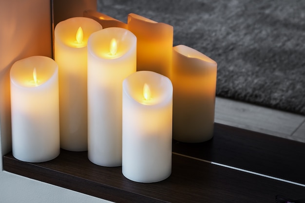 Led electric candles stand in the home