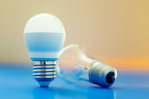 Led light bulb lay next to incandescent bulb