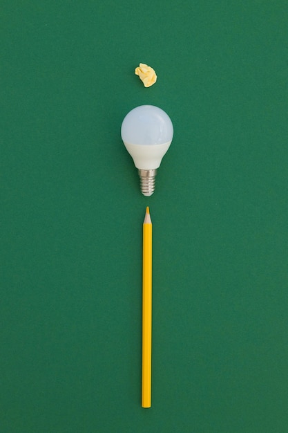 LED light bulb lies on a pastel green background Energy saving concept Minimalism top view