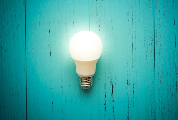 LED light bulb on shabby wood