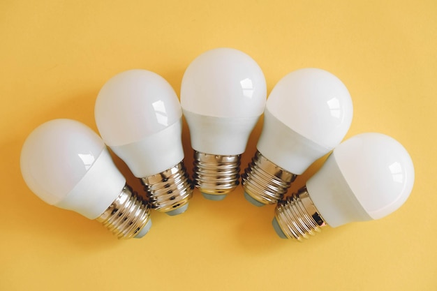 LED light bulbs on yellow background. Top view. Copy, empty space for text