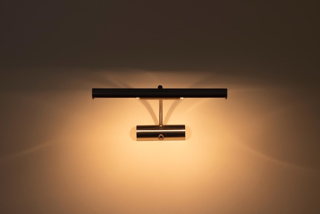 Photo led wall lamp close-up. modern minimalistic bedside lamp for the bedroom