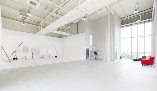 Leeg breed en hoog nieuw schoon industrieel architectuurontwerp voor professionele fotografie indoor studio klaslokaal workshop met hoge glazen ramen met flitsstroboscoop statief reflector apparatuur.