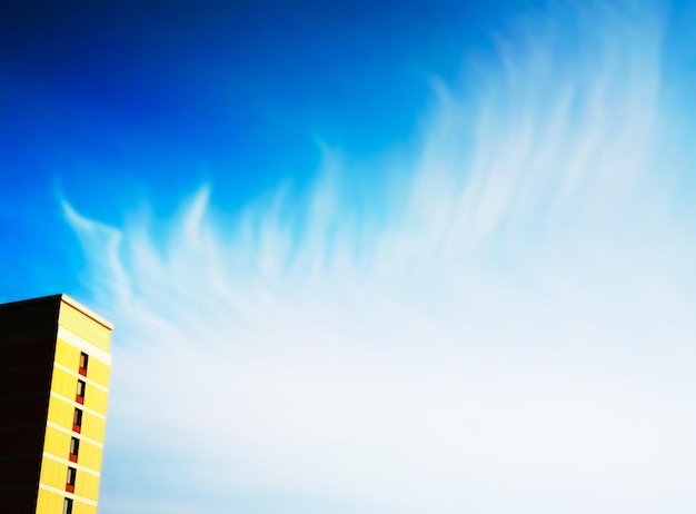 Left aligned building under clean daylight clouds backdrop