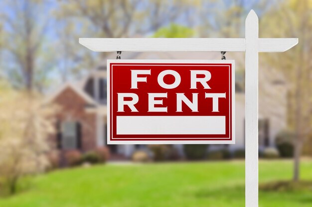 Photo left facing for rent real estate sign in front of house