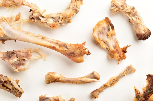 Leftover chicken bones on white background