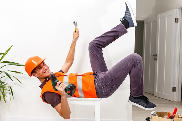 Leg and yellow helmet of injured lying worker at work.