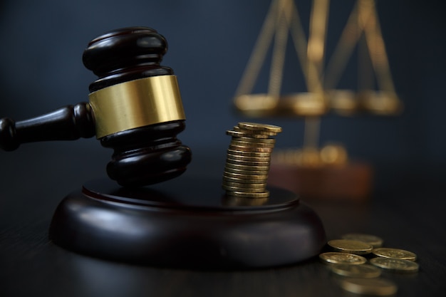 Legal gavel and coins in a coin jar