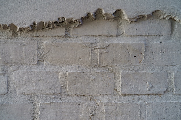 Lege bakstenen muurtextuur. de geschilderde grunge witte obstructie voert oppervlakteachtergrond.