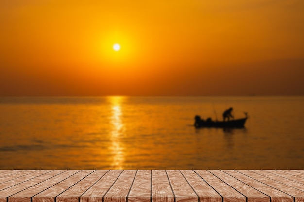 Lege houten tafel op prachtige wazige zee zonsondergang