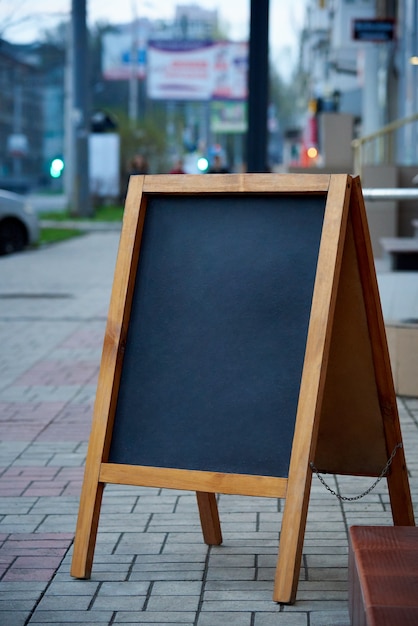 Lege reclamebord op stadsstraat op vage achtergrond.