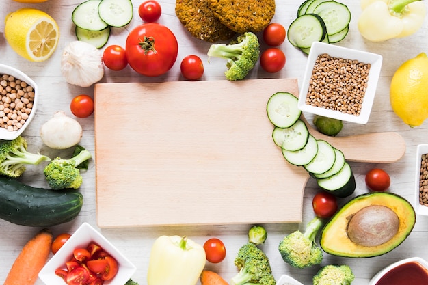 Foto lege snijplank omgeven door veggie eten