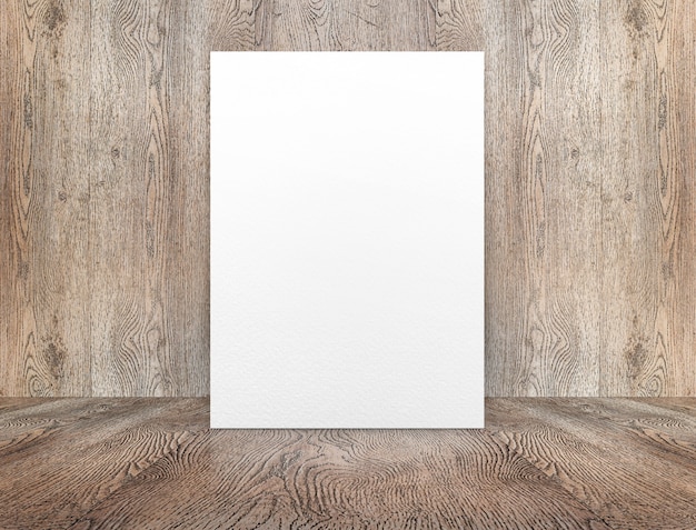 Foto lege witboekaffiche die bij houten muur op houten vloer in perspectiefruimte leunt