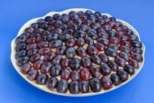 The legendary Tiffany layered salad with grapes, chicken and cheese on the blue background. It got its name from the nickname of the lady who posted the recipe of the salad on the culinary portal.