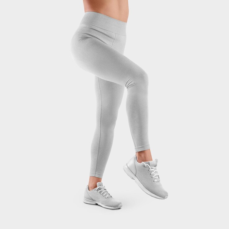 Leggings on a girl in sneakers sportswear  womens pants on an isolated background in the studio