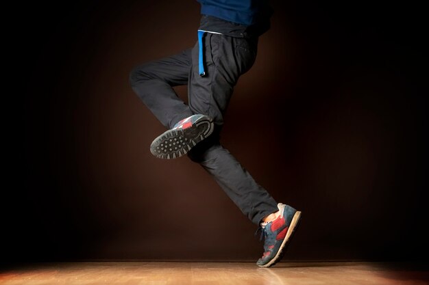 Legs of male dancer on dark background b