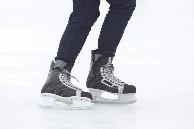 Legs of a man skating on an ice rink