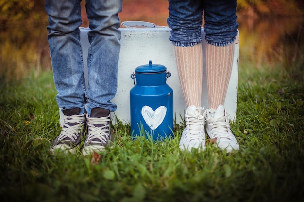 Legs of man and woman grass background