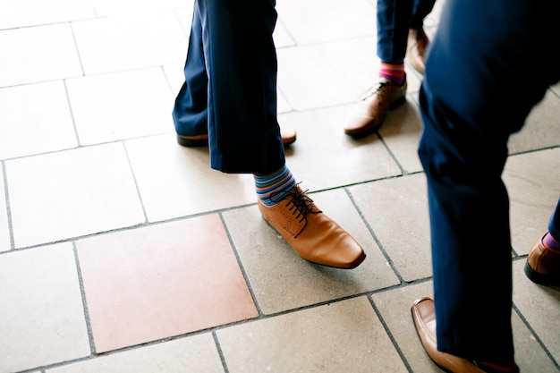 Premium Photo  Male feet in black shoes and blue trousers on the stone  floor closeup