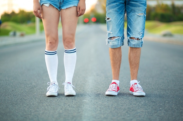 Gambe di una coppia di adolescenti con abiti quotidiani