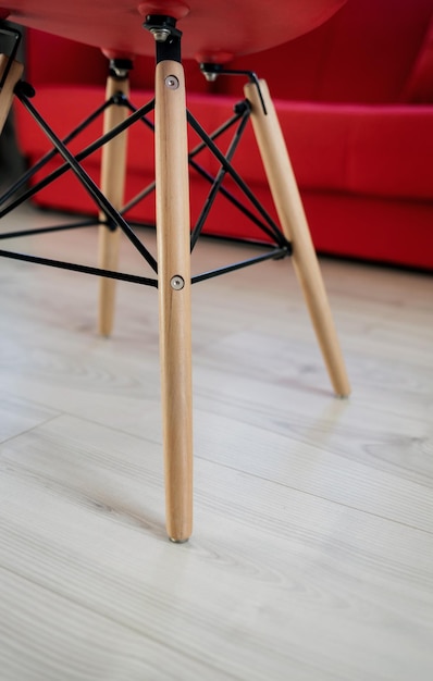 Legs of red chair on floor