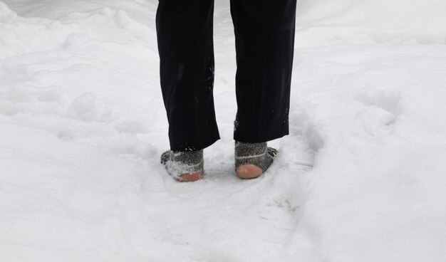 legs in torn socks in the snow