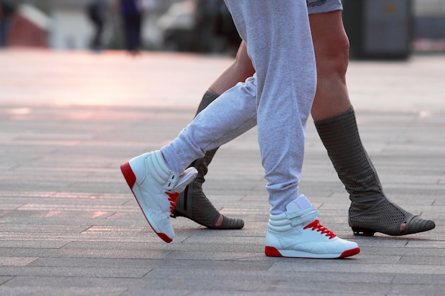 Legs of two people walking