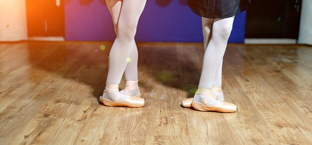 Premium Photo  Legs of young ballerinas rehearse in the ballet class  dressed in white pantyhose and ballet shoes pointe shoes concept