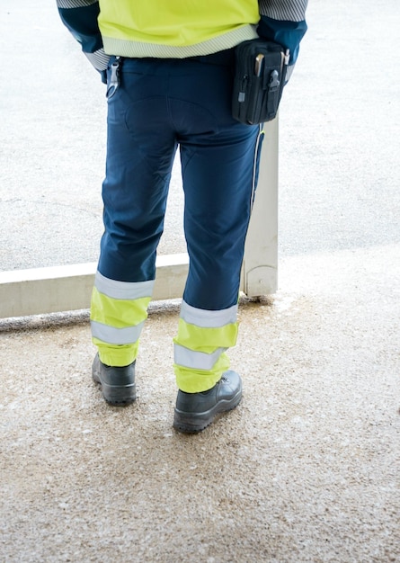 Legs with reflective pants and black working boots