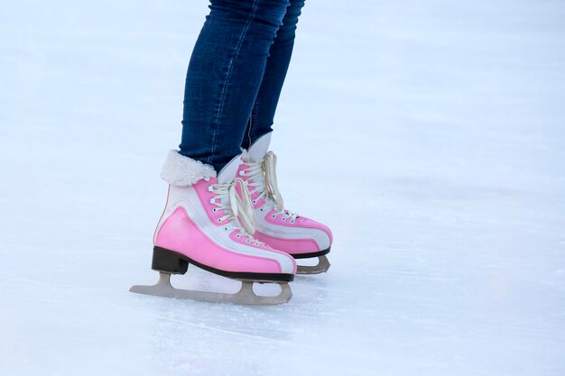 Legs of a woman ice skating on an ice rink. hobbies and leisure. winter sports