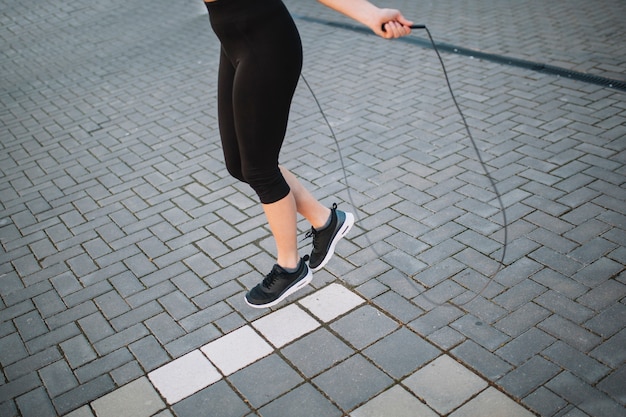 Legs of woman skipping rope