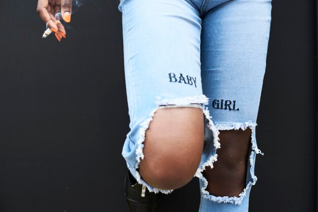 Photo legs of woman wearing used look jeans