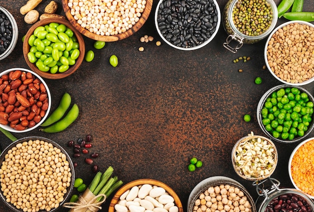 Legumes beans and sprouts dried raw and fresh top view red\
beans lentils mung beans chickpeas soybeans edamame green peas\
healthy diet food vegan protein micronutrients fiber sources