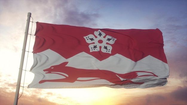 レスターシャーの旗、イギリス、風、空、太陽の背景に手を振っています。 3Dレンダリング